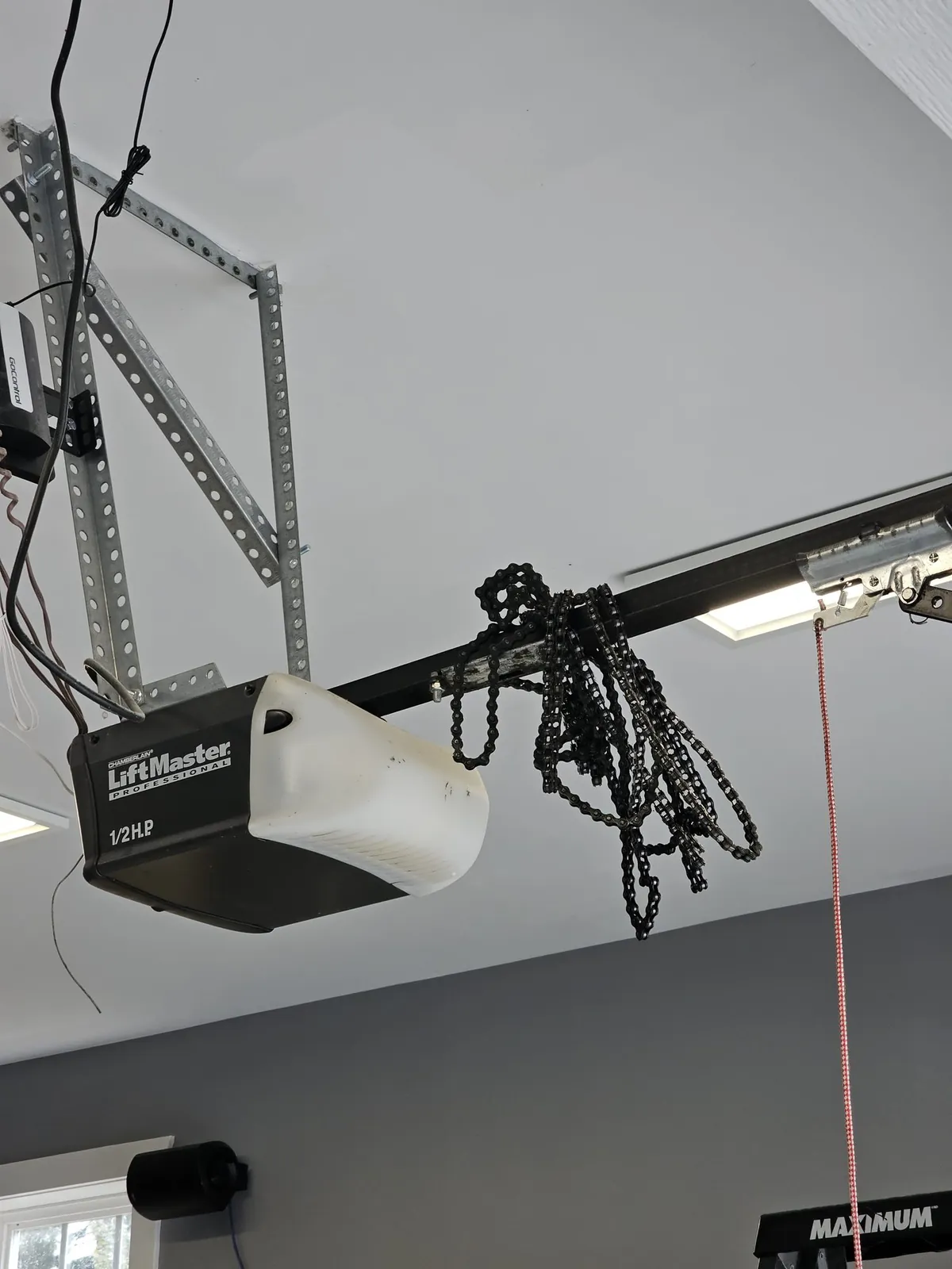 Older Chamberlain LiftMaster opener with a worn drive chain — repair-or-replace decision