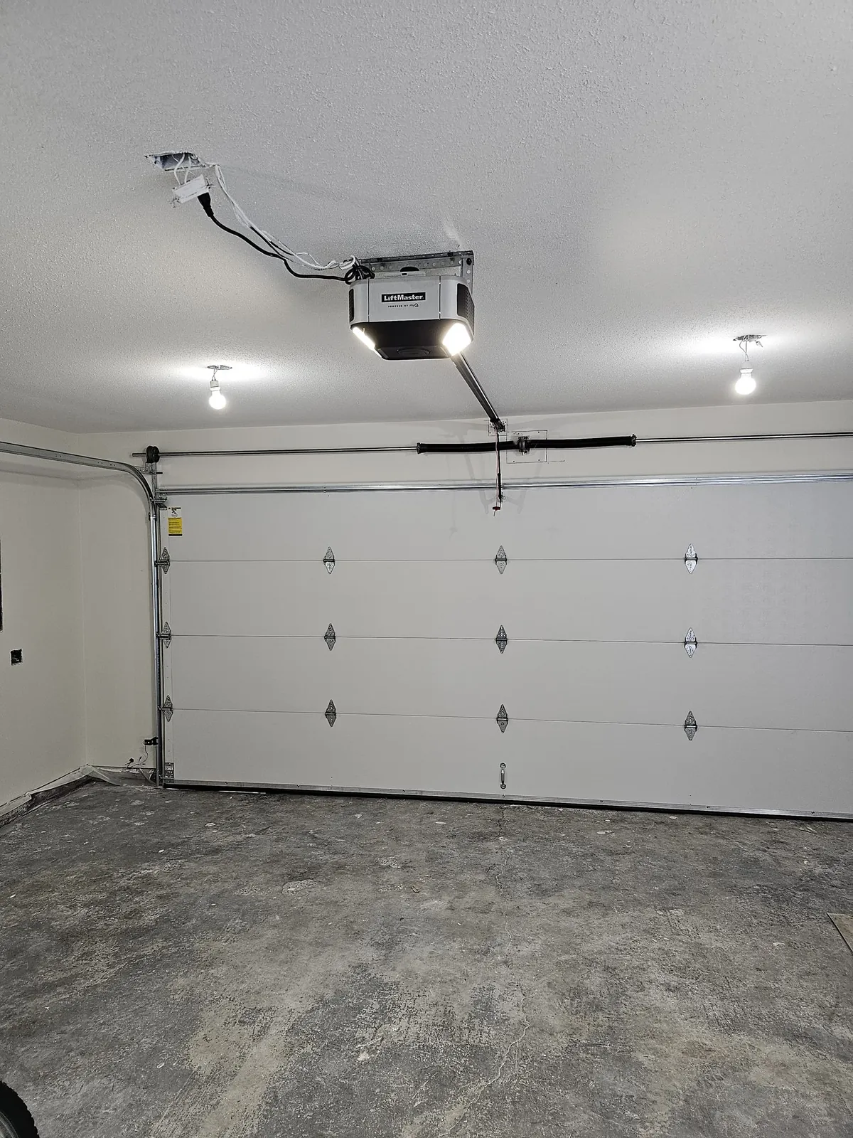 LiftMaster smart opener installed above a new garage door in a Tsawwassen Springs garage
